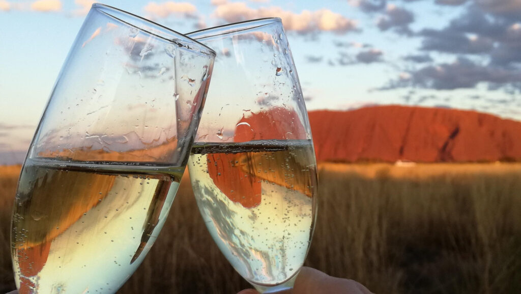 Two glasses of champagne raised in celebration during a special vacation