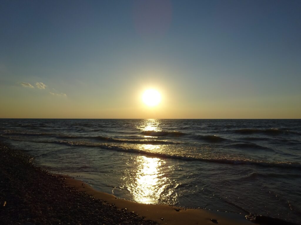 Sunrise over a peaceful lake representing calm, meaningful travel experiences